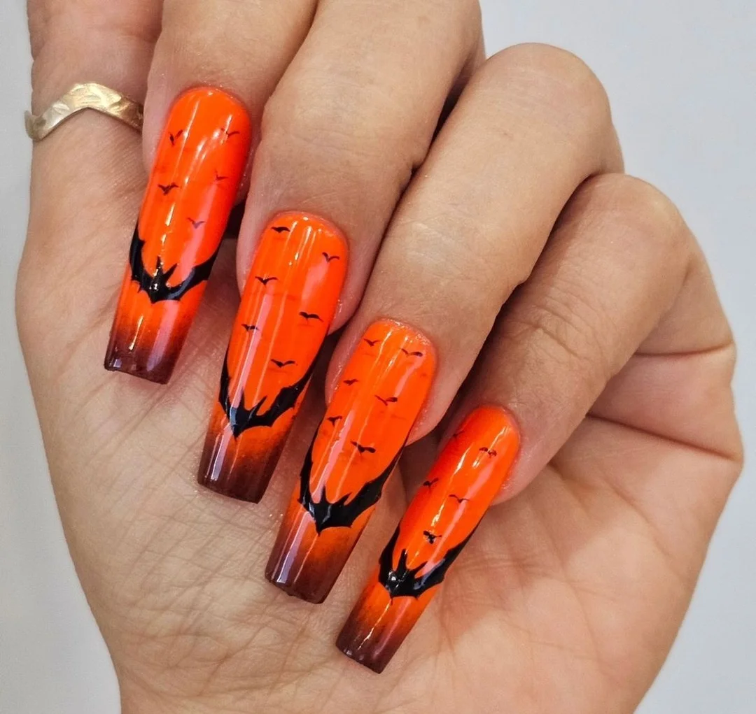 Fiery Orange Nails with Hauntingly Bold Details