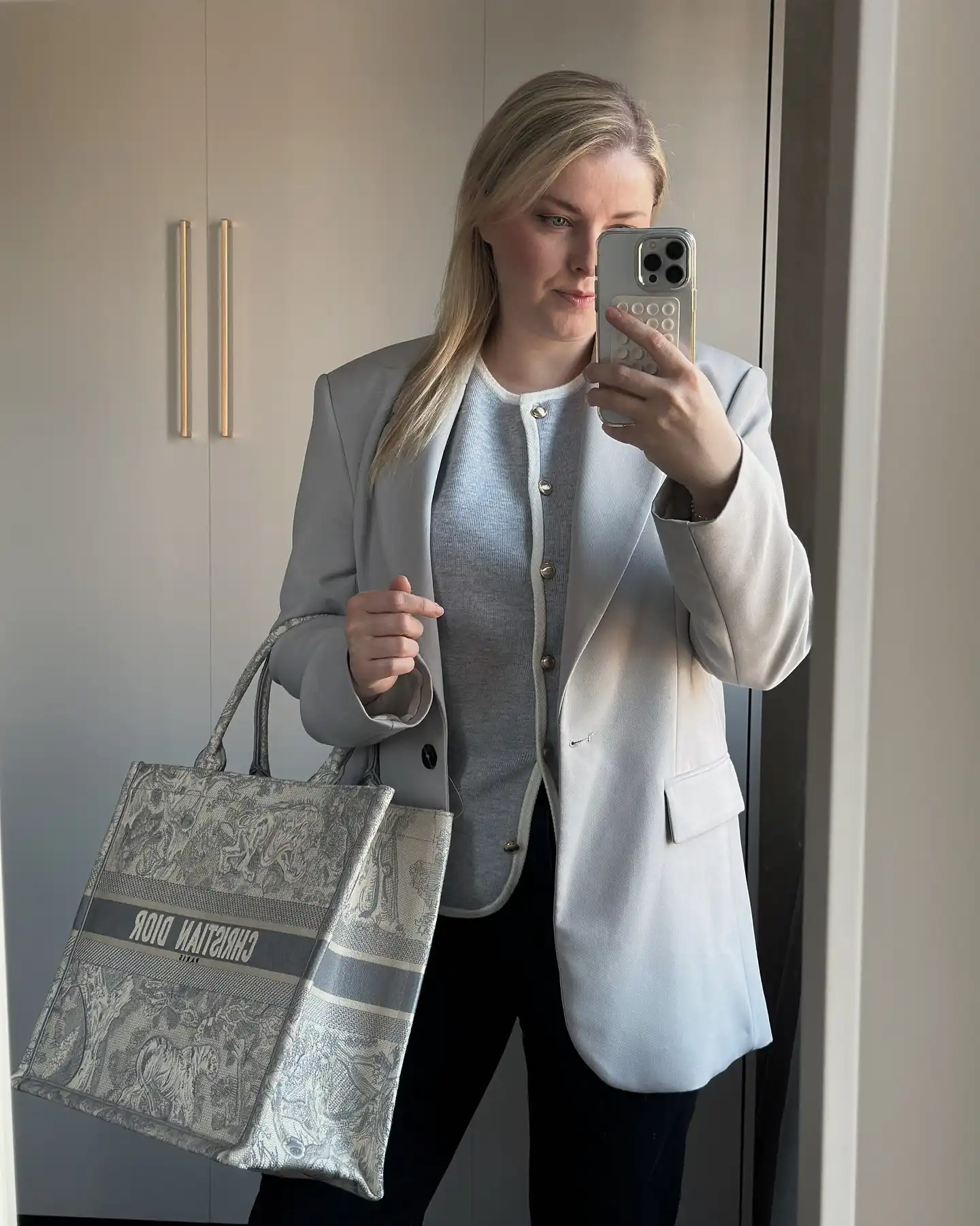 Soft Gray Blazer With a Buttoned Knit and Black Trousers