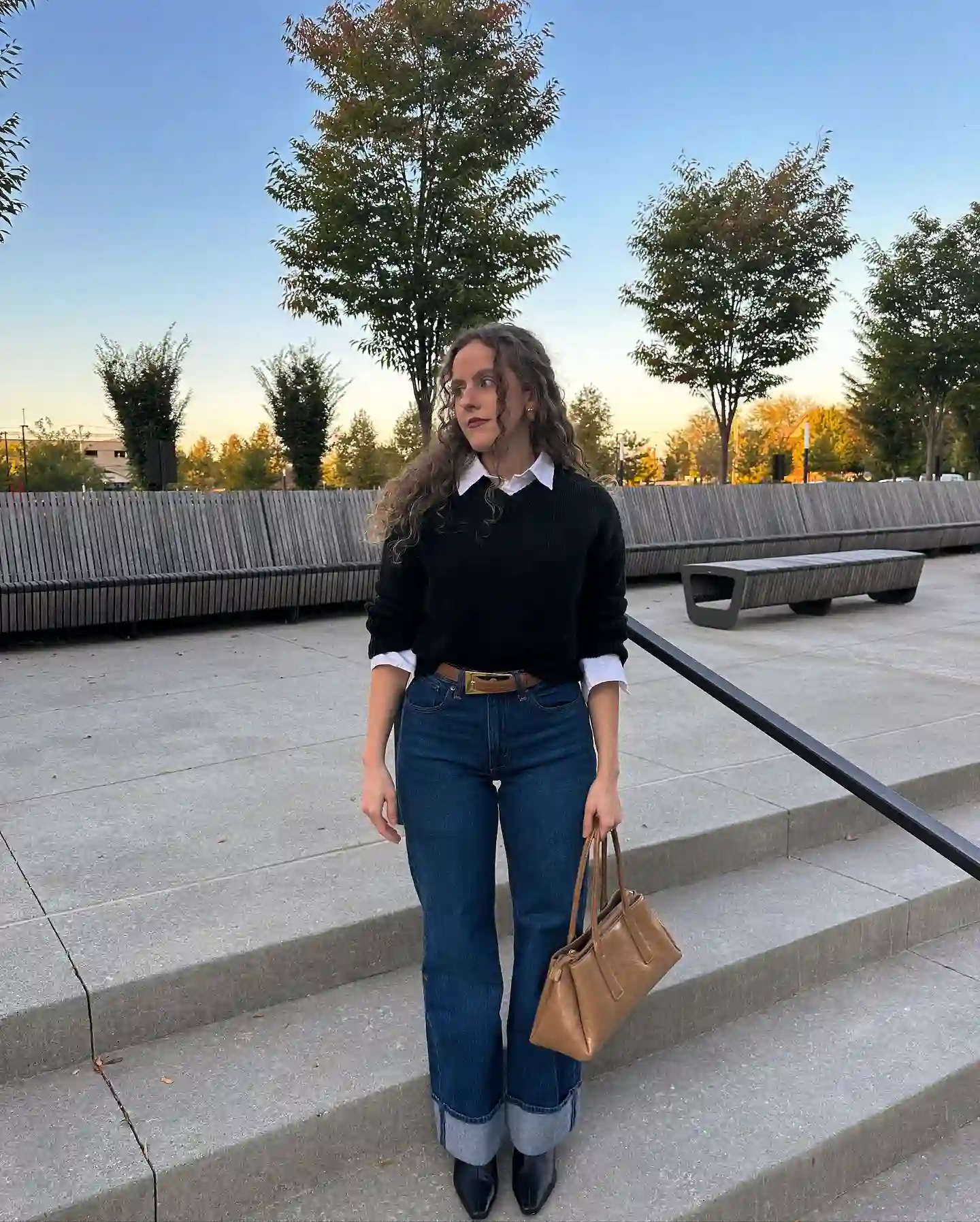 Layer a Crisp Collared Shirt Under a Simple Black Sweater