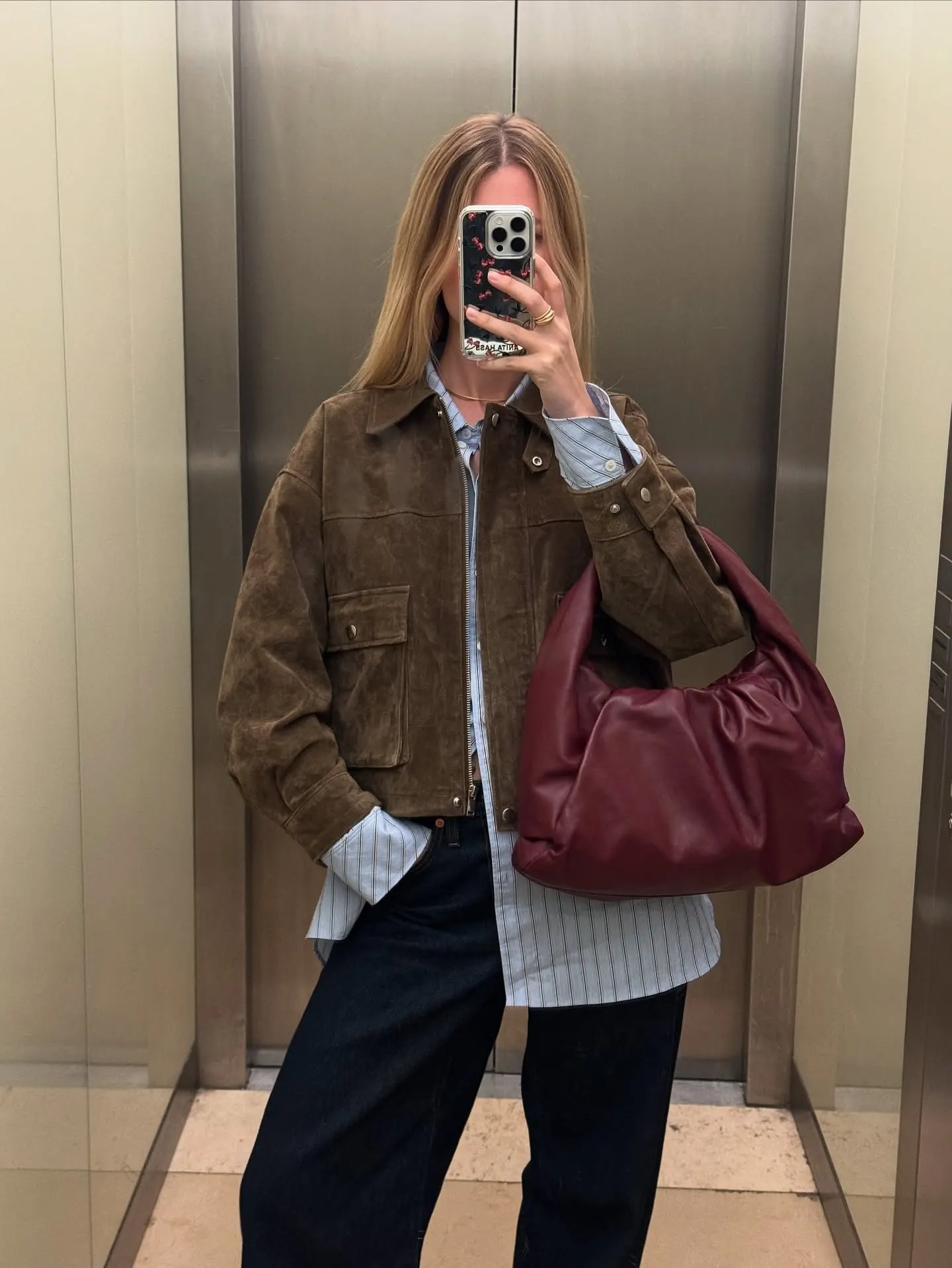 Brown Cropped Jacket With a Striped Shirt and Dark Trousers