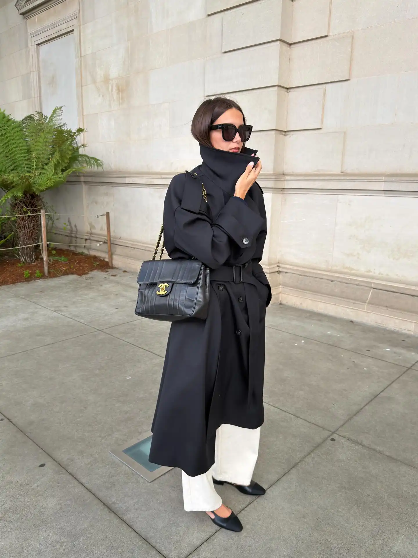 Black Trench Coat With White Pants For A Minimal Fall Outfit