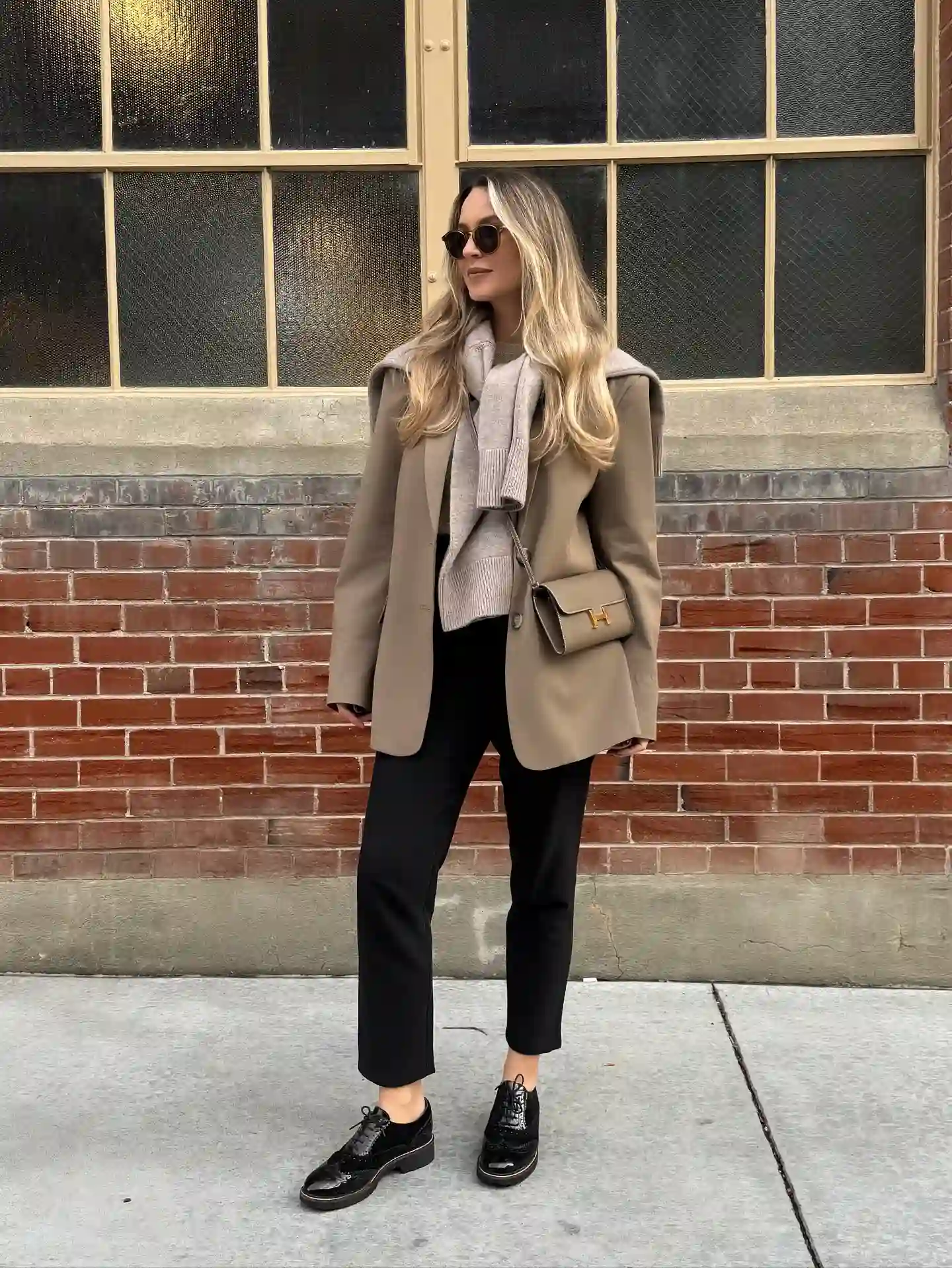 Taupe Blazer With Layered Knits and Cropped Black Trousers