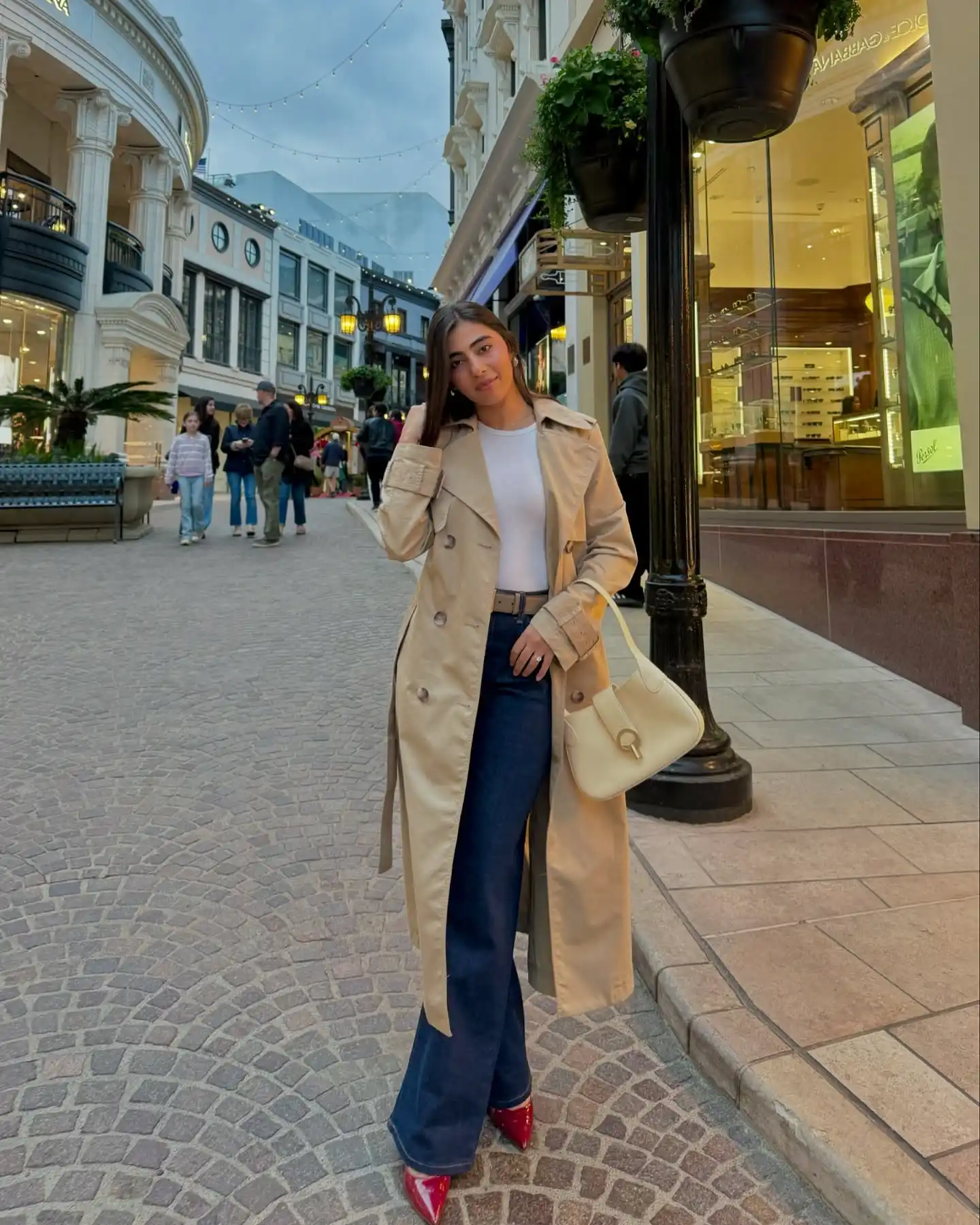 Dark Denim and Red Shoes Add Contrast to a Classic Trench Coat