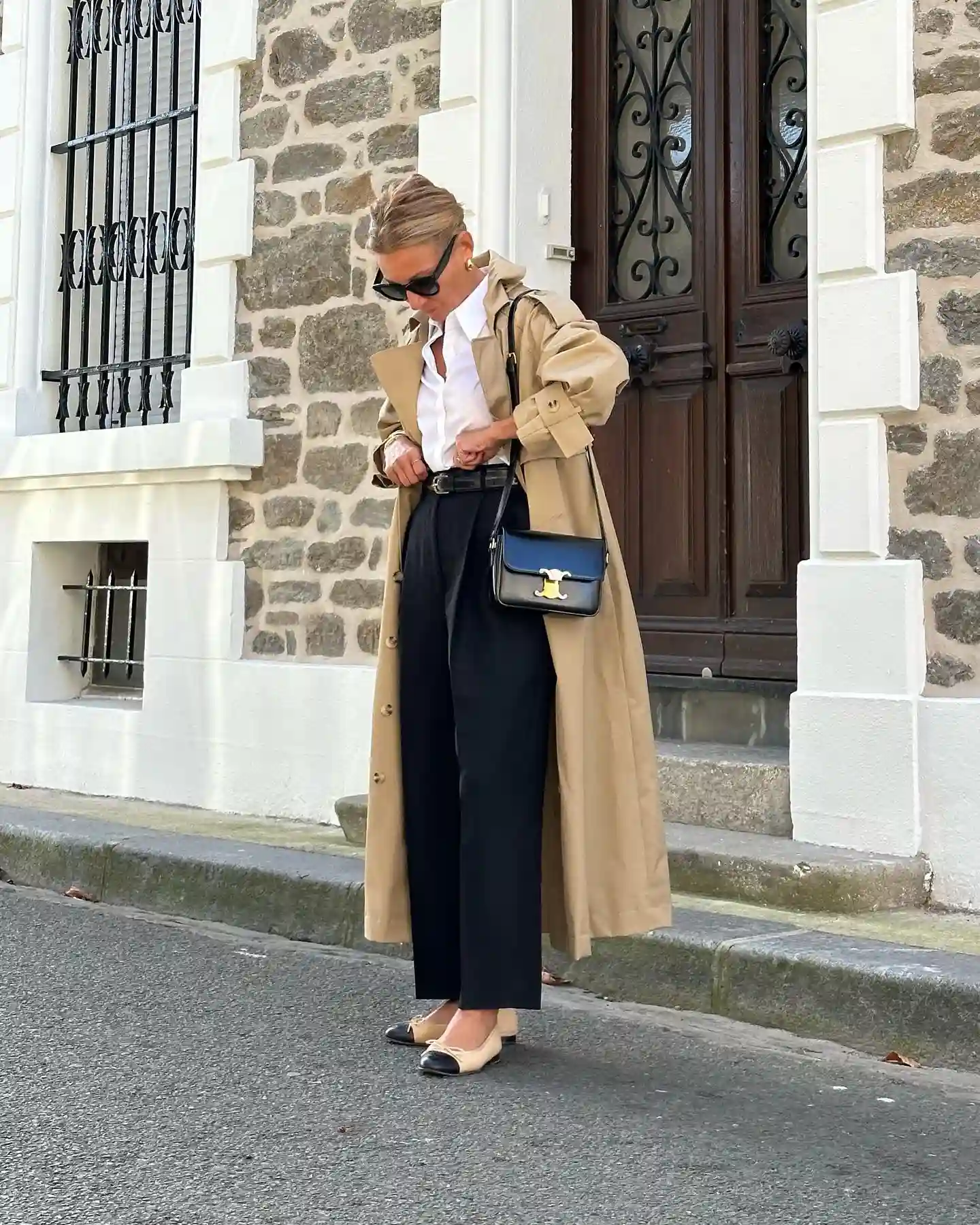 Camel Trench Coat With Black Trousers For A Classic Fall Office Look